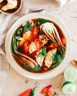 Dumplings in a bowl of broth and vegetables and chilli made with Beef bone broth