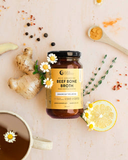 a flat lay image of a jar of beef bone broth concentrate lemon ginger acv