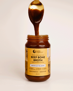 A Gif image of a teaspoon coming out of a jar of beef bone broth concentrate lemon ginger ACV
