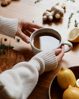 two hands reach out to pick up a mug of broth made from Beef bone broth concentrate