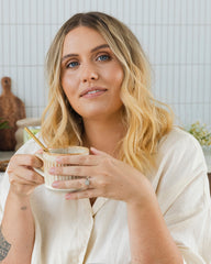 A woman holding a cup