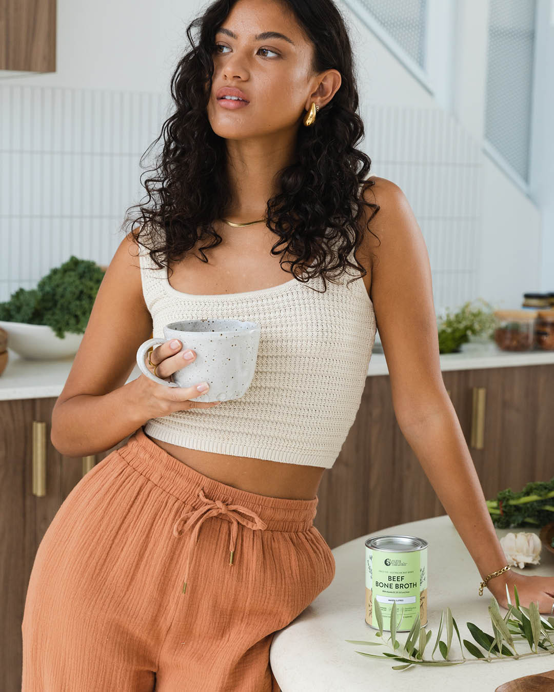A Woman holding Beef Bone Broth Powder can
