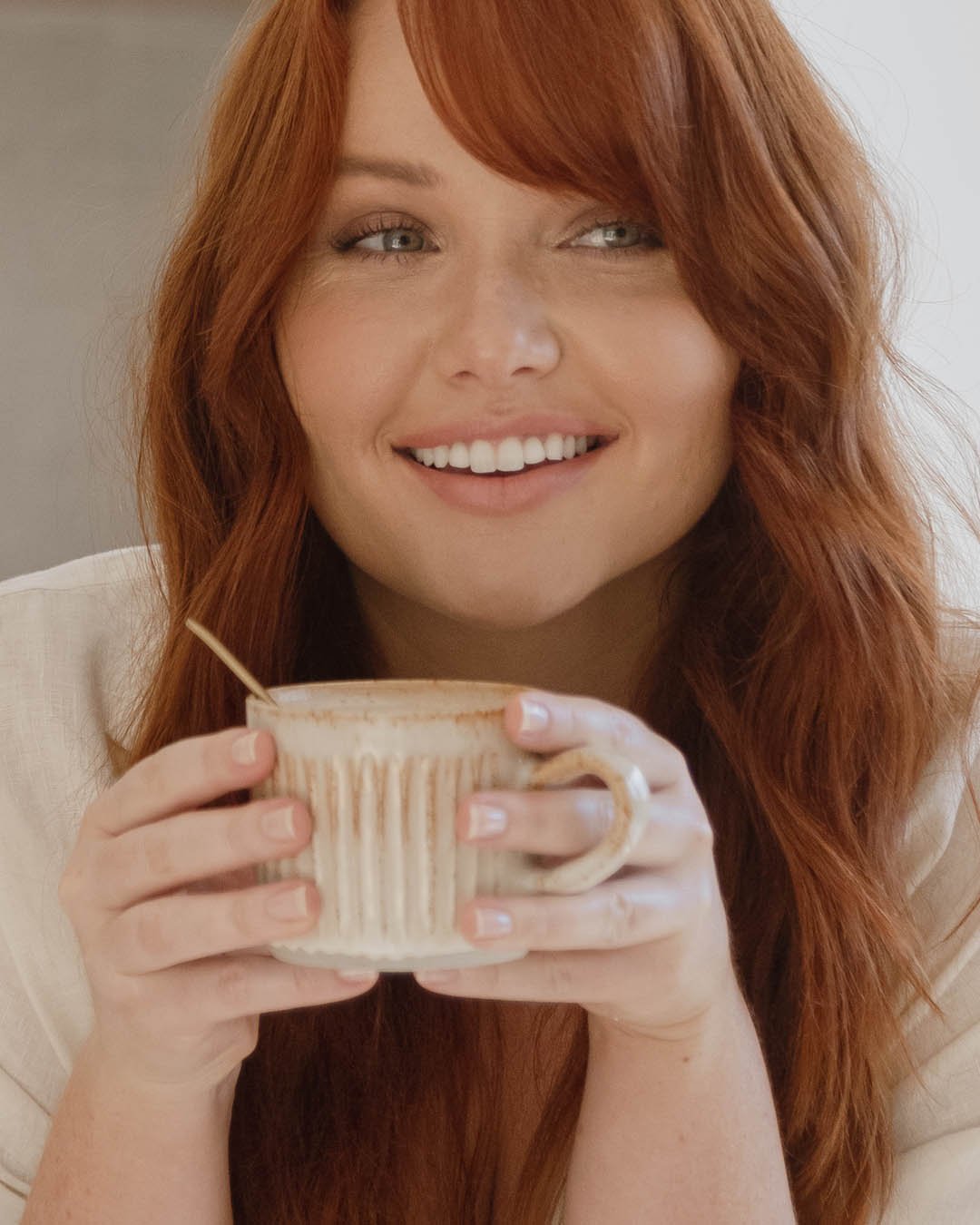 Lady holding a cup of collagen beauty drink