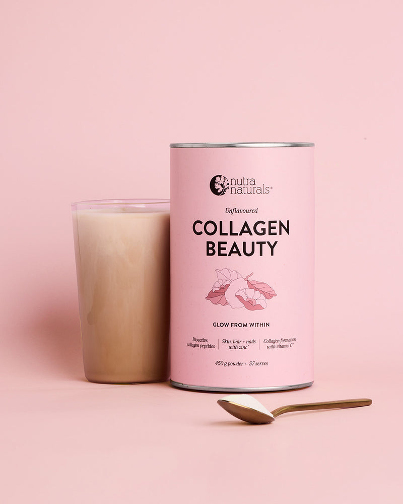 A pink canister of Nutra Naturals Collagen Beauty powder stands next to a glass of drink