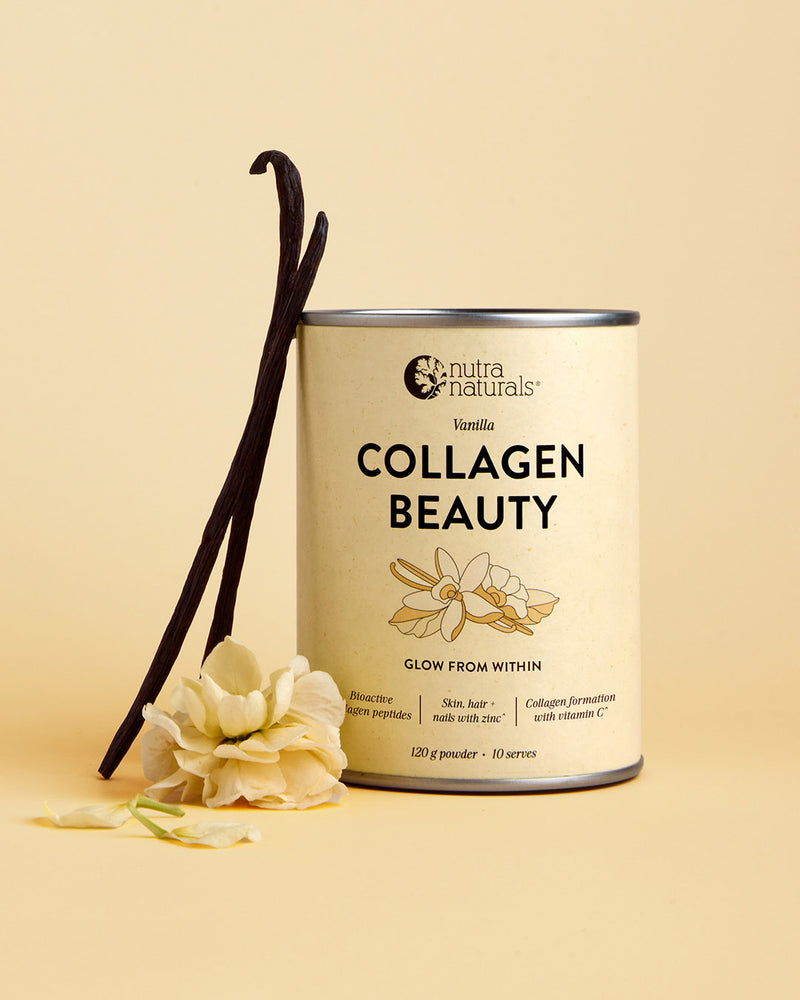 A canister of Nutra Naturals Collagen Beauty vanilla powder, styled with vanilla beans and a vanilla flower on a warm beige background.