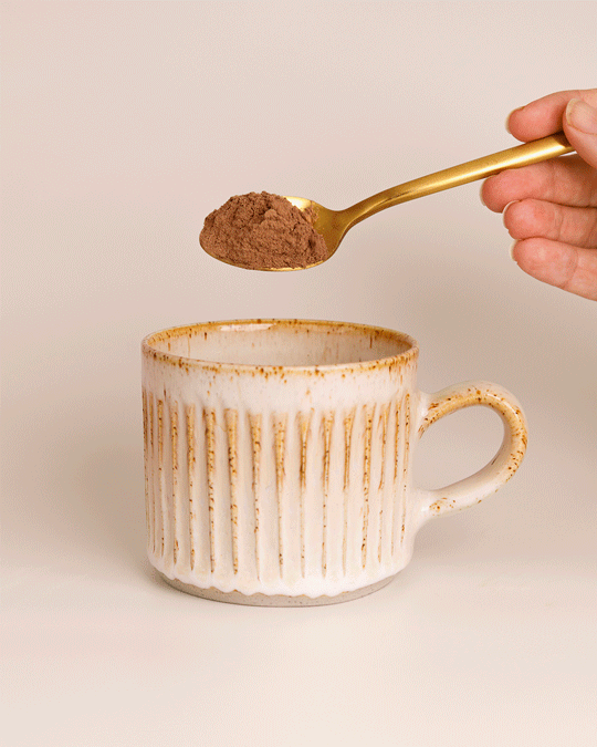 GIF: Collagen Beauty hot chocolate powder being poured into a mug
