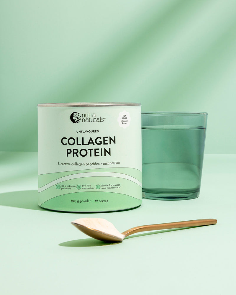 Collagen Protein powder stands on a mint green surface next to a glass of water 