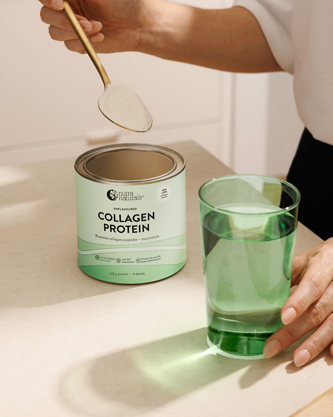 A person getting a spoonful of Collagen Protein