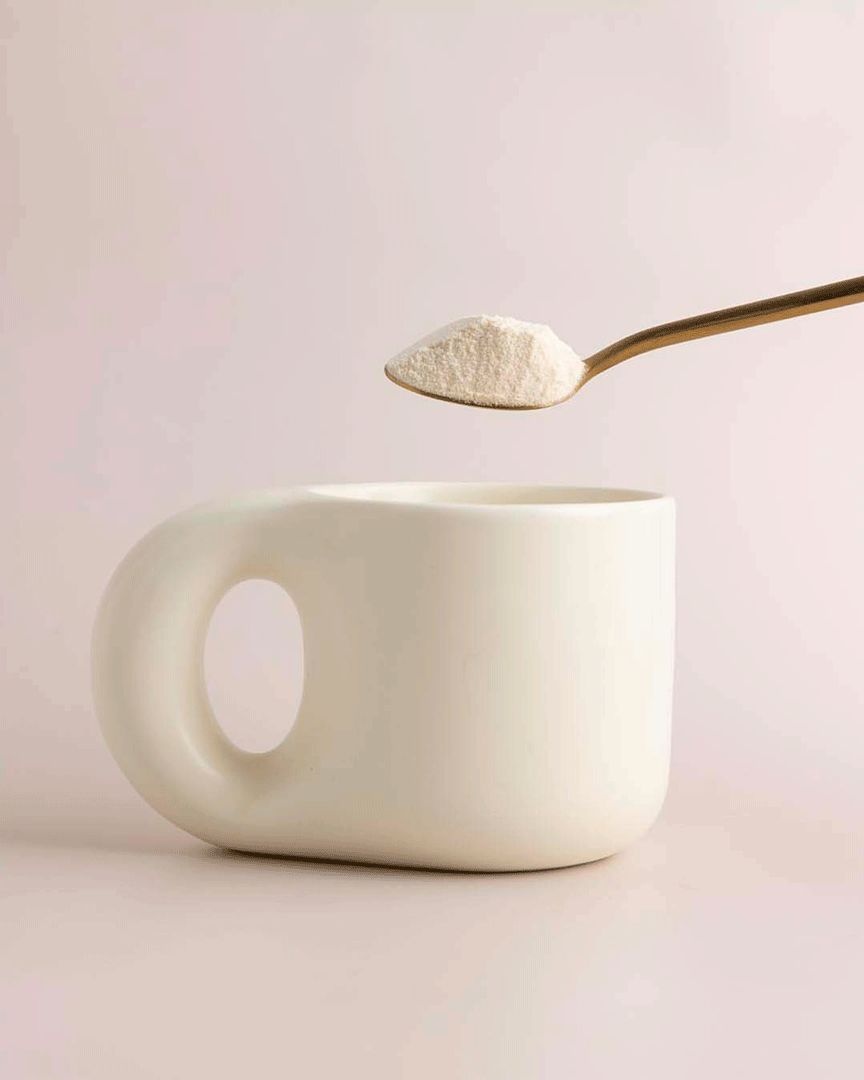GIF: Collagen salted caramel white hot chocolate powder being poured into a mug