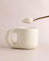 GIF: Collagen salted caramel white hot chocolate powder being poured into a mug