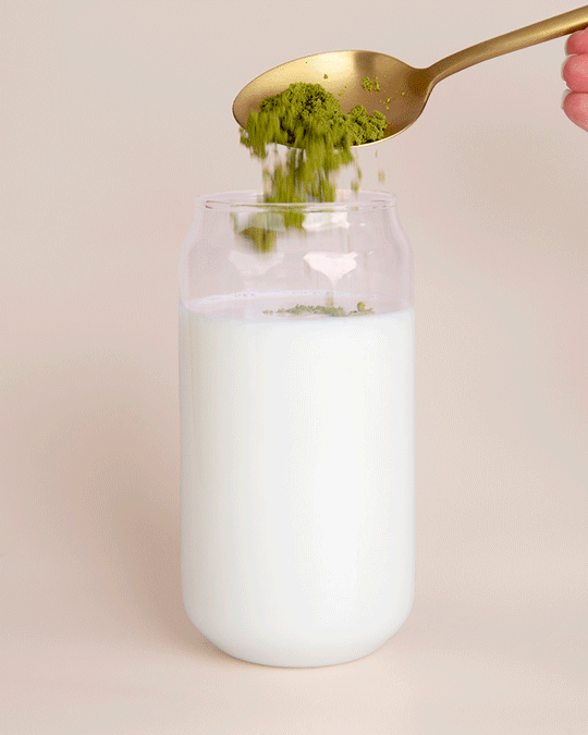 GIF: Collagen Matcha Latte powder being stirred into a glass of water