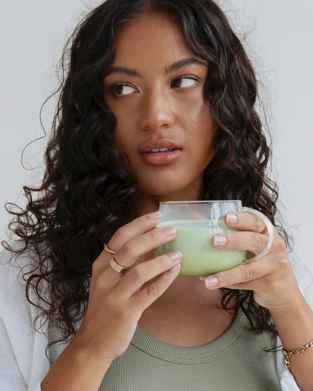 Lady holding a glass of Collagen Matcha Latte