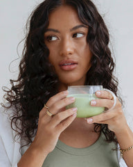 Lady holding a glass of Collagen Matcha Latte