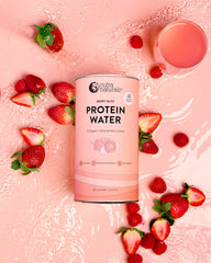 Protein water canister with strawberries and a glass of protein water drink 