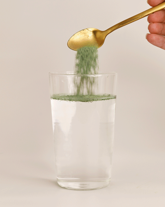 GIF: Super Greens + Reds Watermelon Strawberry powder being stirred into a glass of water