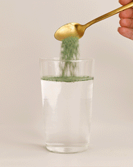 GIF: Super Greens + Reds Watermelon Strawberry powder being stirred into a glass of water
